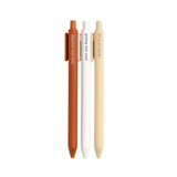 Faith-based pens writing spiritual phrases in ink, laid out on a flat-lay with a notepad.

