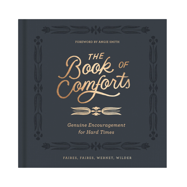 Cover of “The Book of Comforts: Genuine Encouragement for Hard Times” featuring gold embossed title on navy hardcover.