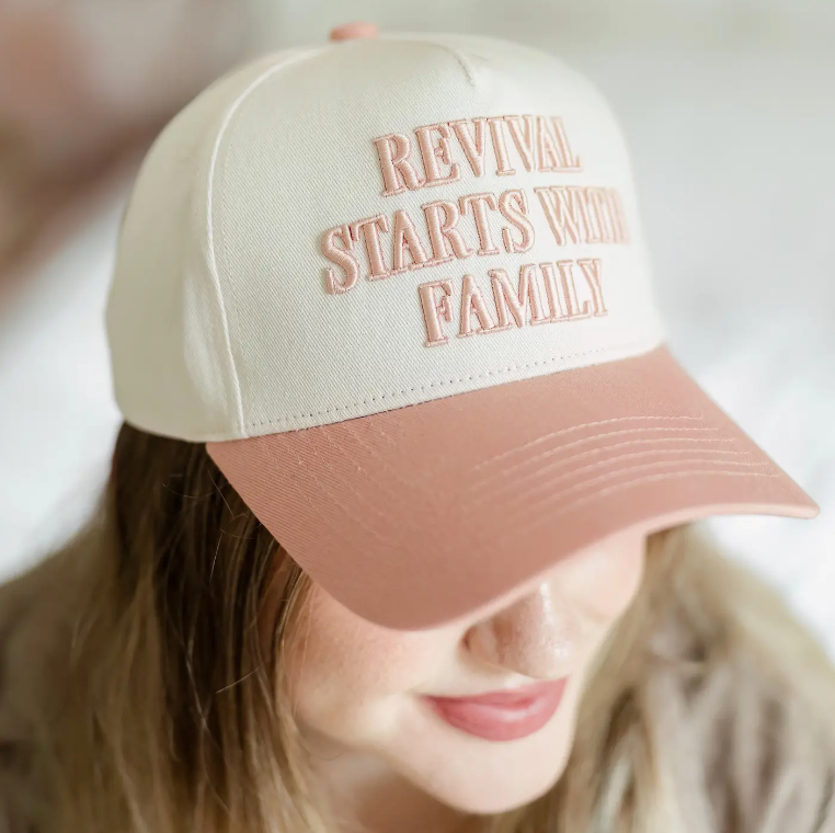 Beige and pink Christian cap with "Revival Starts with Family" text, available at a Lakeland, Florida clothing store.