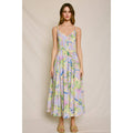 Woman wearing a floral dress against a plain background