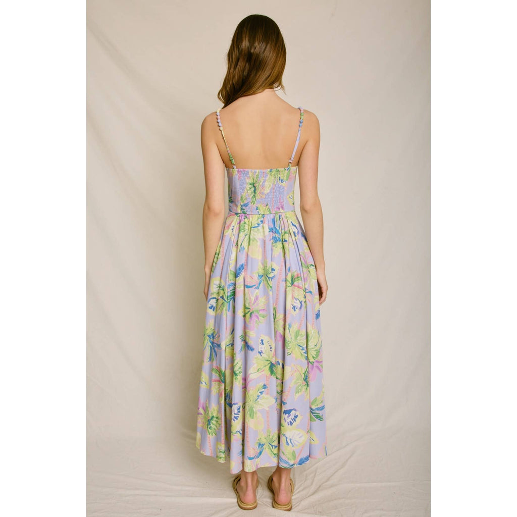 Woman wearing a floral dress against a plain background