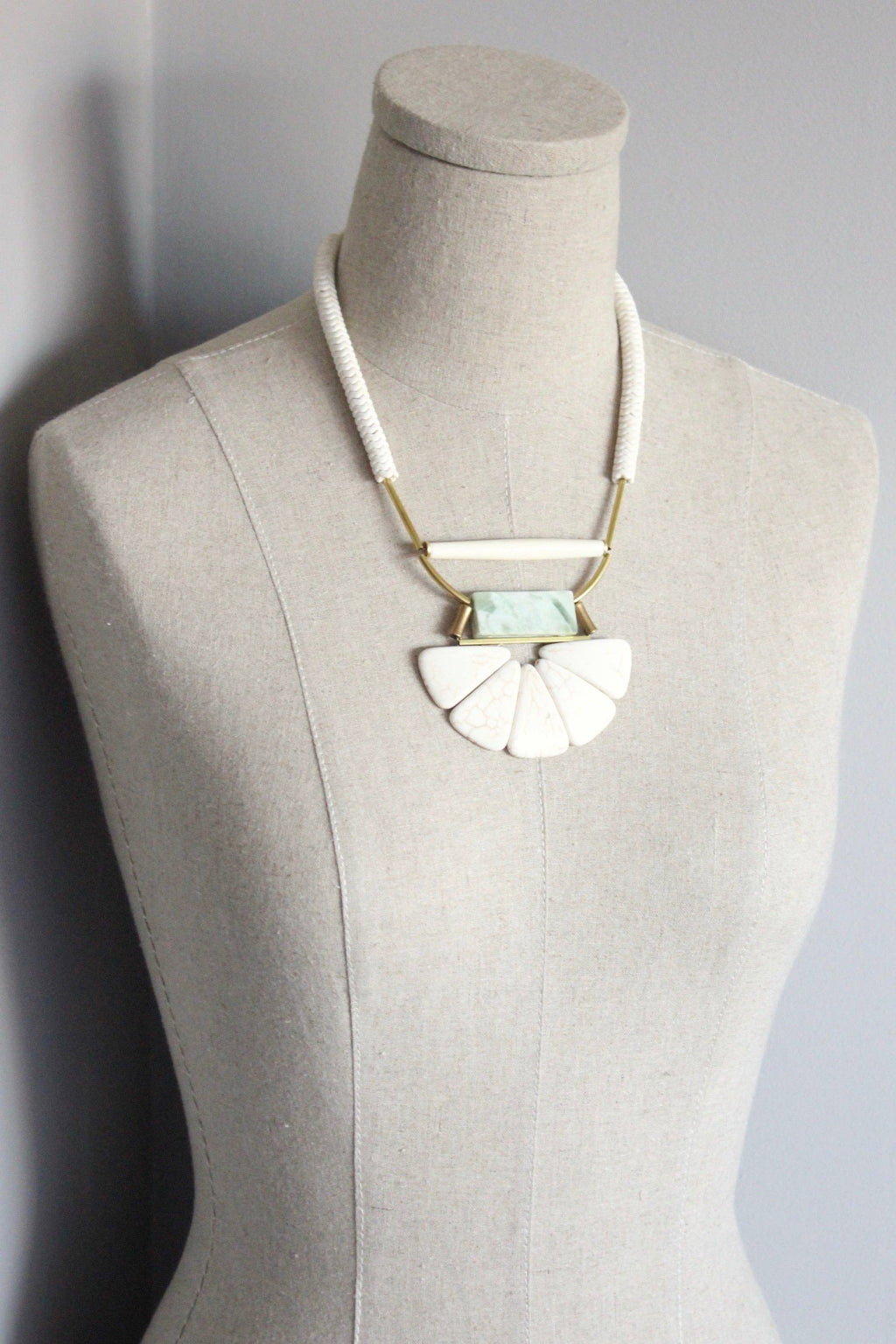 Magnesite, horn, serpentine, and brass necklace
