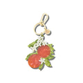 Keychain with orange and flower design on a white background