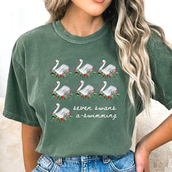 Young Woman wearing green tshirt with seven swans a swimming printed on it and blue jeans.